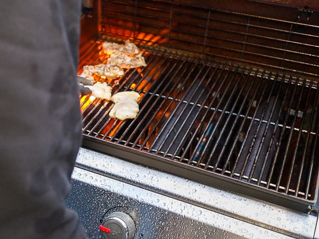 buffalo chicken thighs on a grill
