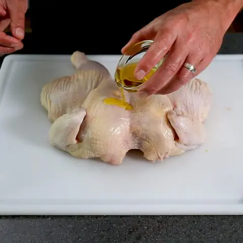 prepping the a chicken with oil
