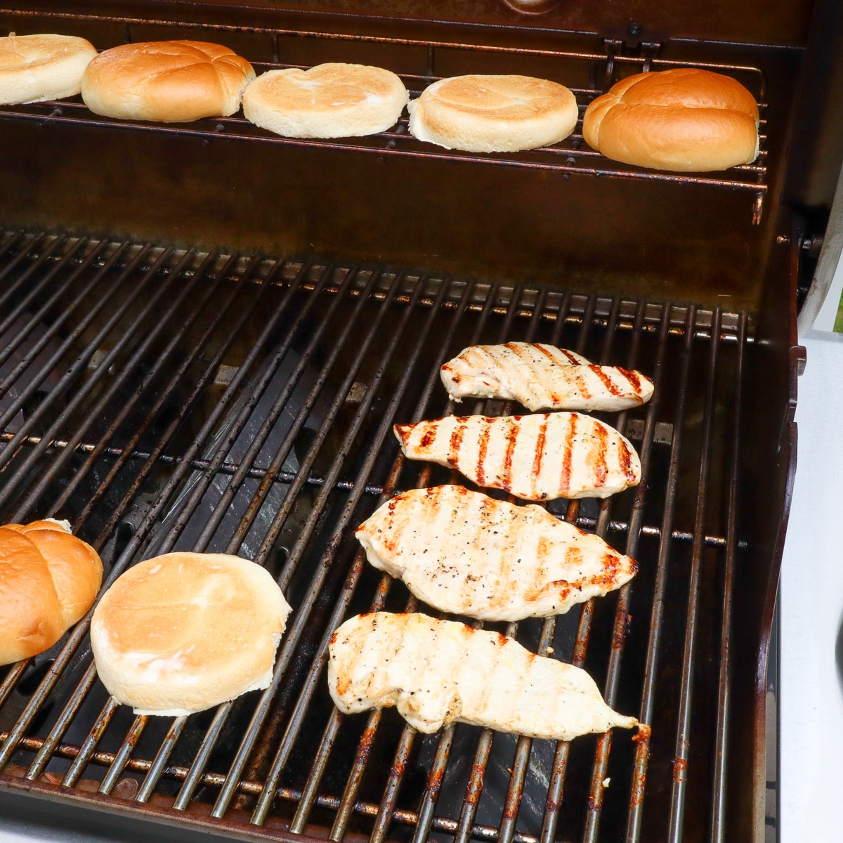 buns and chicken being grilled