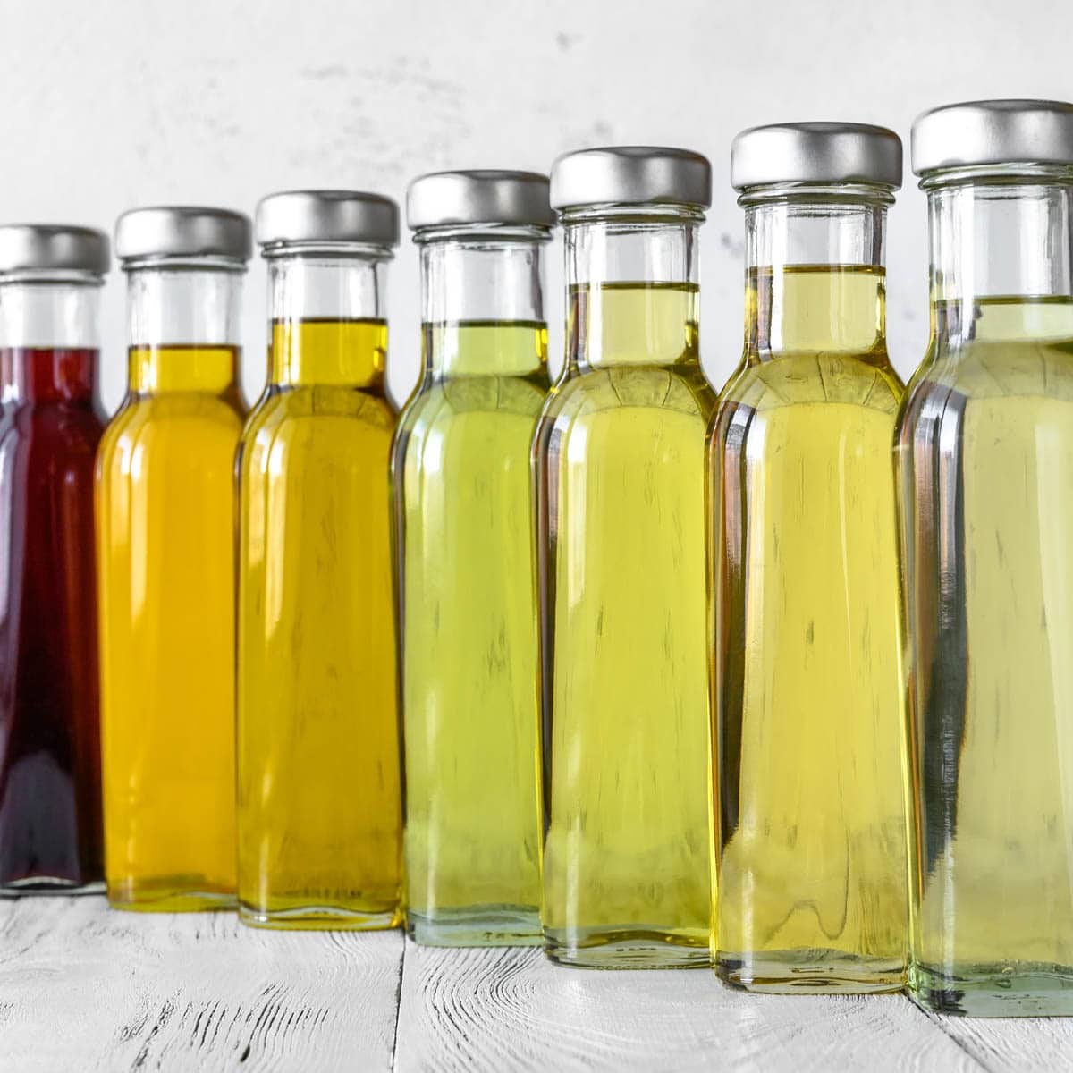 Bottles of different cooking oils lines up from light to dark
